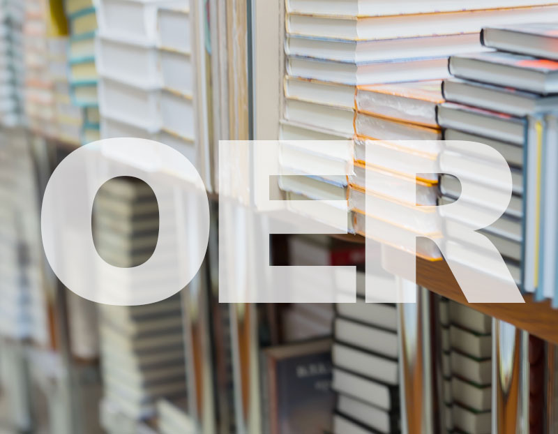 Stack of books in background of letters "OER"