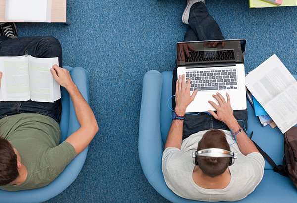 People sit in comfy chairs while reading and browsing the internet