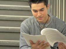 Person reads packet of papers on stairs