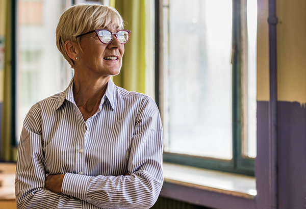 Person looks outside window pondering best teaching advice