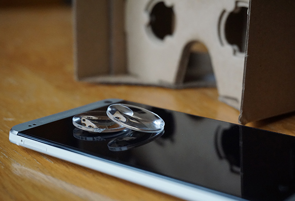 Tablet lays on table with VR glasses behind tablet