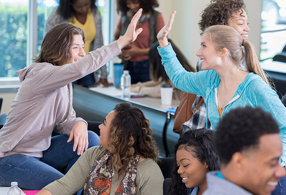 Students high-five in class