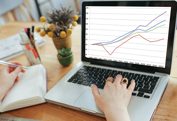 Person looks at computer screen that displays a graph on kitchen counter