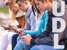 Students along bench holding phones with the word "UDL" along the side