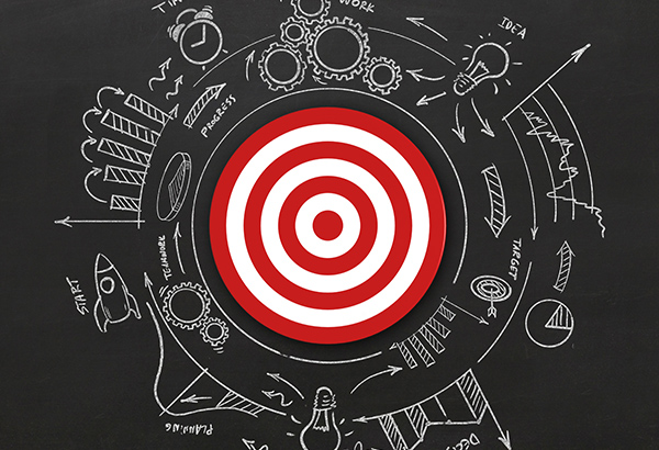 Bullseye on chalkboard represents aligning educational assignments