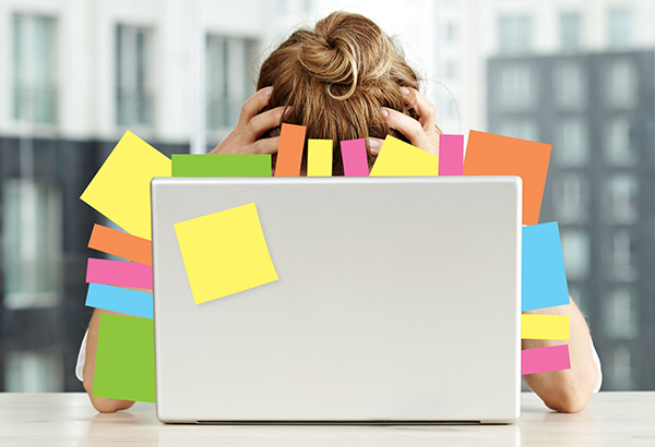 overwhelmed-in-front-of-computer-tons-of-sticky-notes