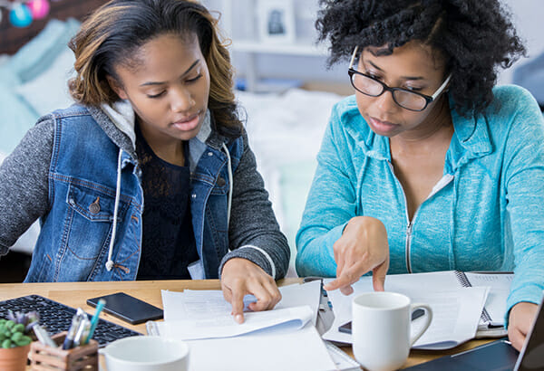 Two women looking over papers for authentic assessment