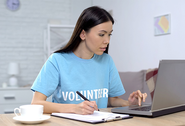 woman-taking-notes-and-typing-on-computer