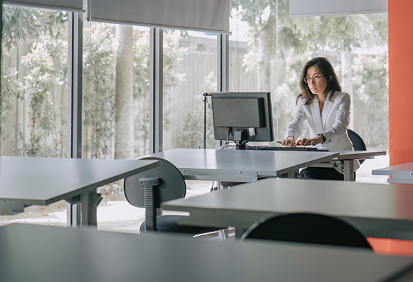 woman-working-alone-in-room-on-computer