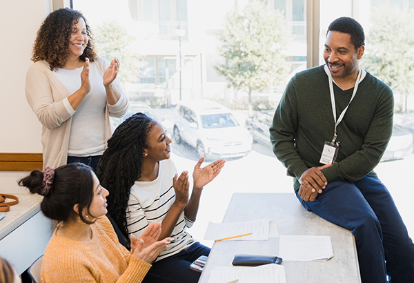 teacher-in-front-of--engaged-students-talking