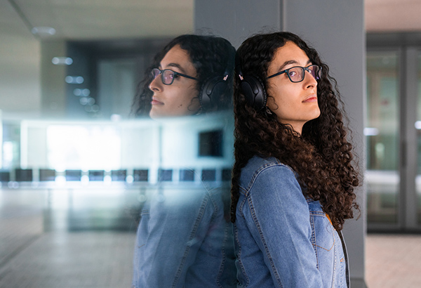 person-leaning-against-window-thinking