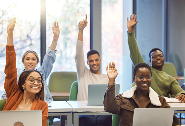 grou-of-diverse-students-in-classroom-happily-raising-their-hands