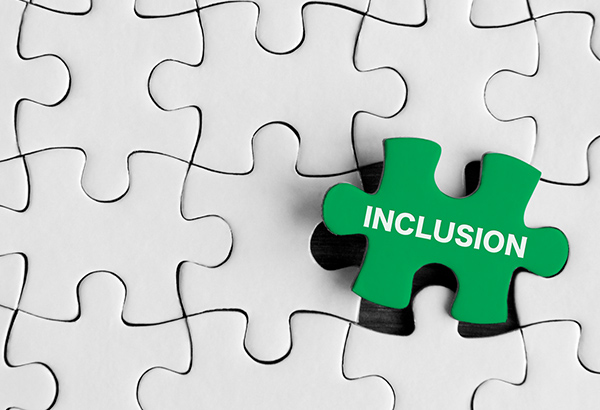 white-puzzle-pieces-with-green-piece-that-says-inclusion